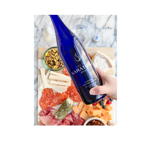 saratoga natural spring water held over charcuterie board Image3