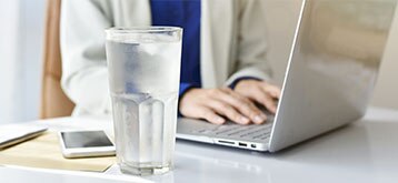 Working woman with a glass of water