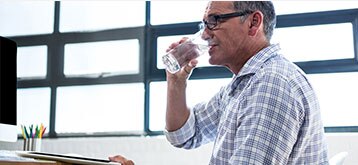 Working man drinking a glass of water