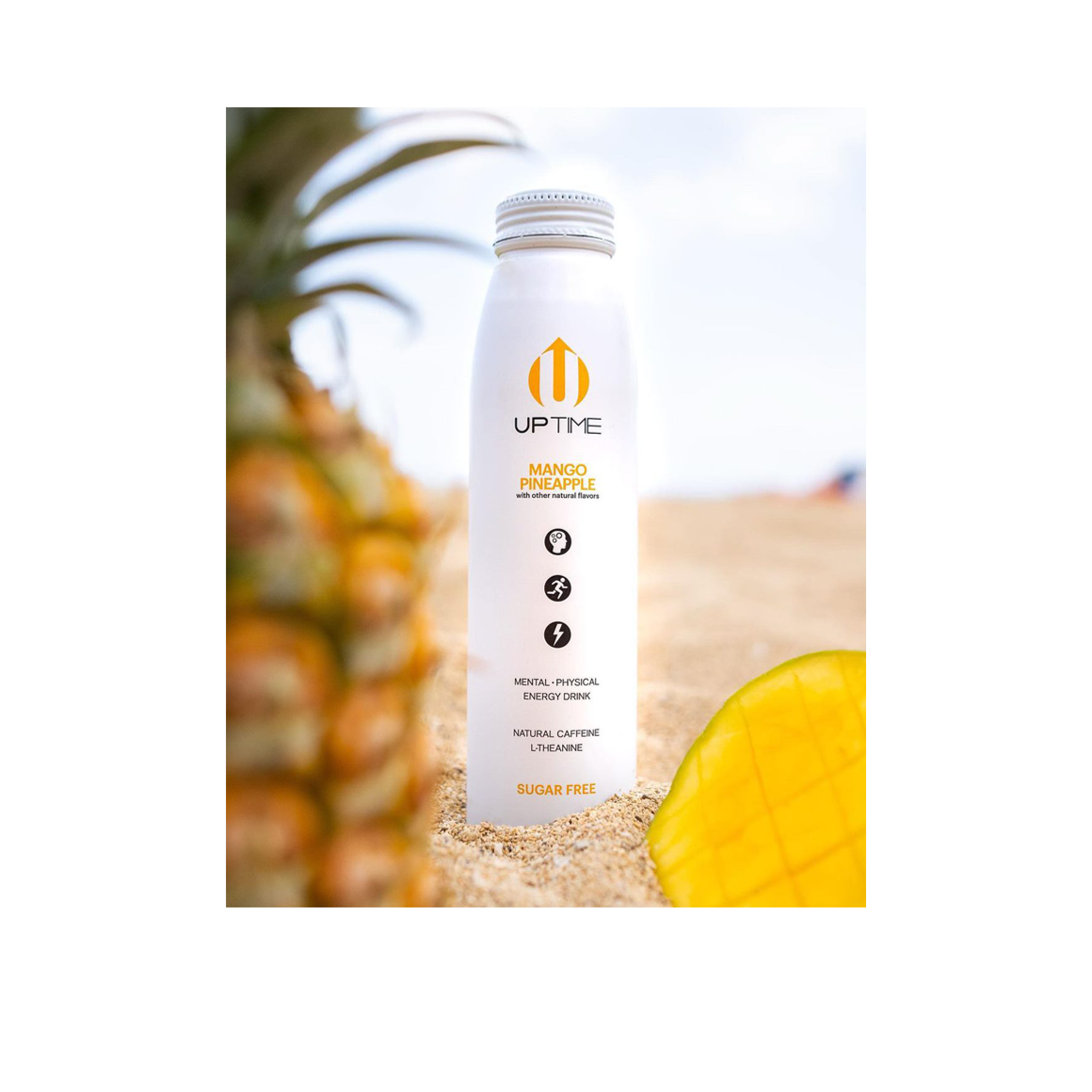 bottle of uptime mango pineapple energy drink on the beach Image2